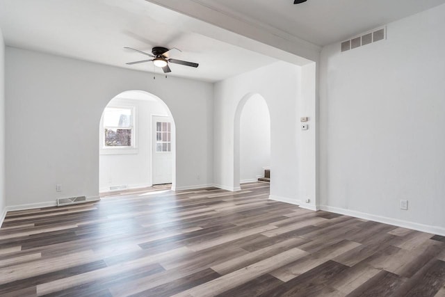 unfurnished room featuring ceiling fan, visible vents, and wood finished floors