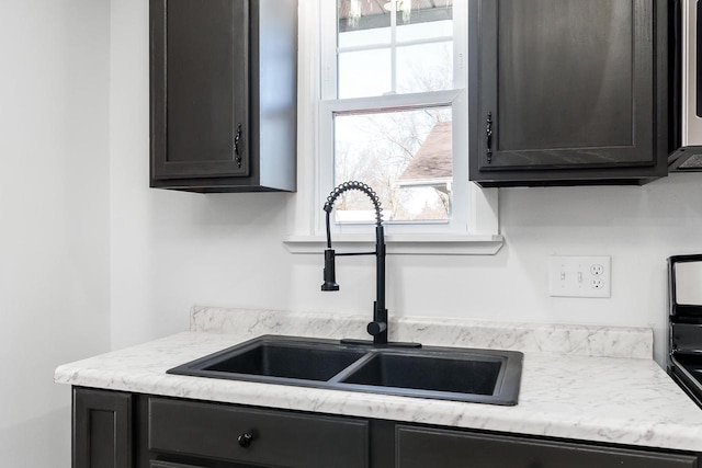 kitchen featuring stainless steel microwave and a sink