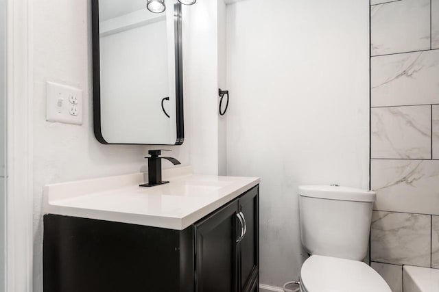 bathroom with toilet and vanity