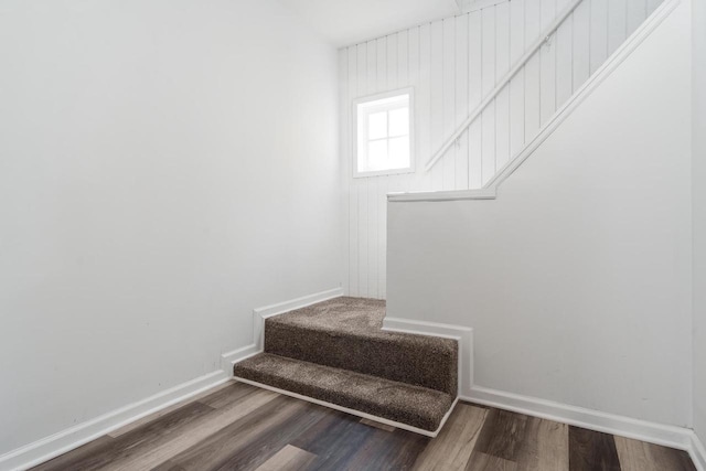 stairs with wood finished floors and baseboards