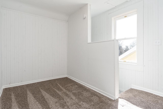 carpeted empty room with baseboards