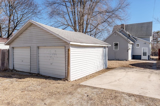 detached garage featuring fence