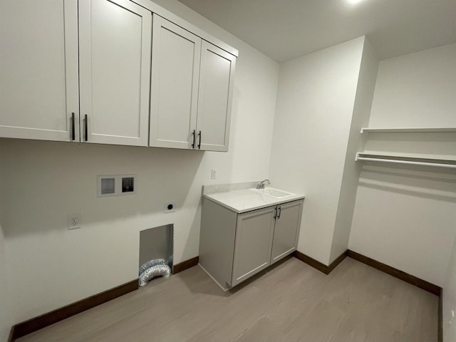 laundry room featuring electric dryer hookup, baseboards, cabinet space, and washer hookup