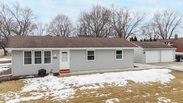 ranch-style house with a garage, roof with shingles, and entry steps