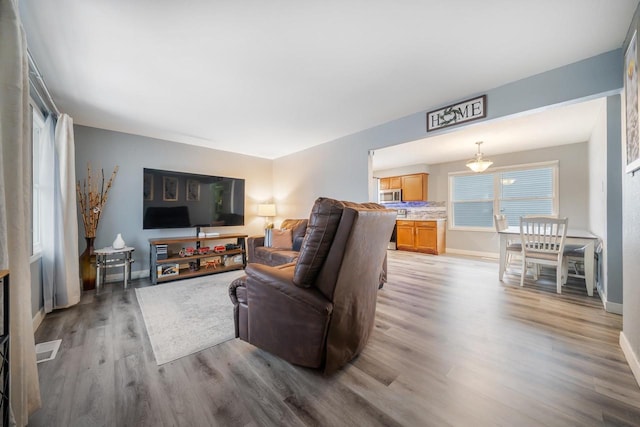 living area featuring wood finished floors and baseboards