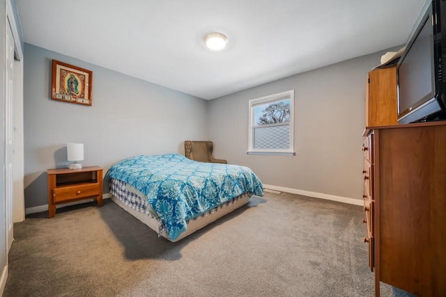 bedroom with carpet flooring and baseboards