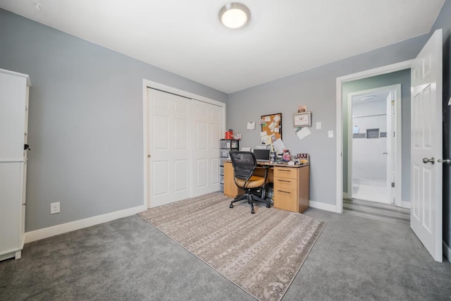 carpeted home office featuring baseboards