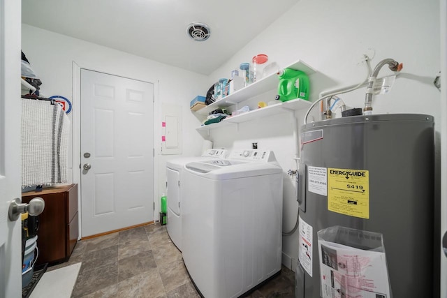 washroom with laundry area, visible vents, stone finish floor, water heater, and separate washer and dryer