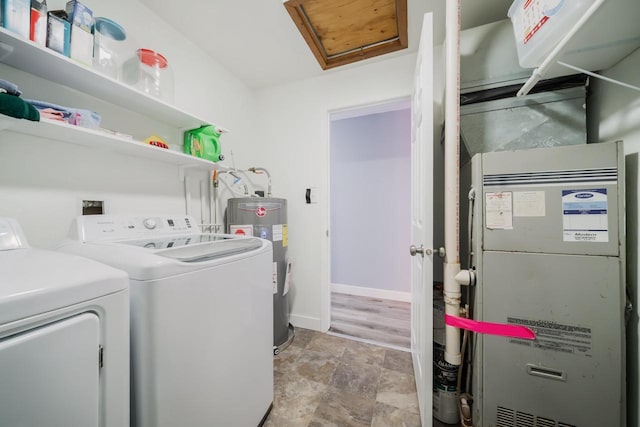 laundry area featuring laundry area, attic access, baseboards, washer and clothes dryer, and electric water heater