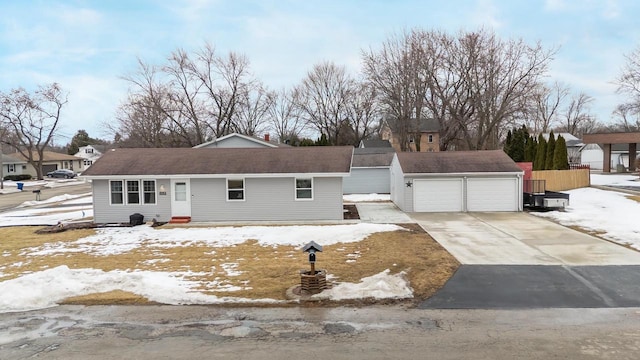 view of front of property featuring an outbuilding, concrete driveway, and a garage