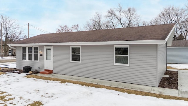 view of front of house featuring entry steps and roof with shingles