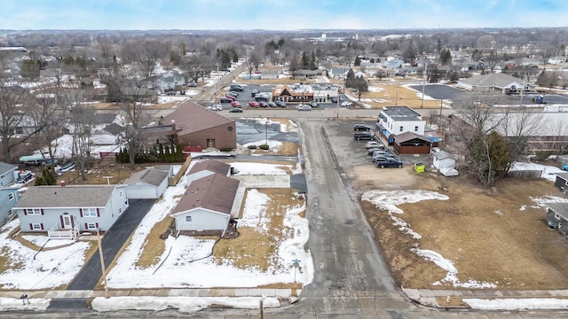 snowy aerial view with a residential view