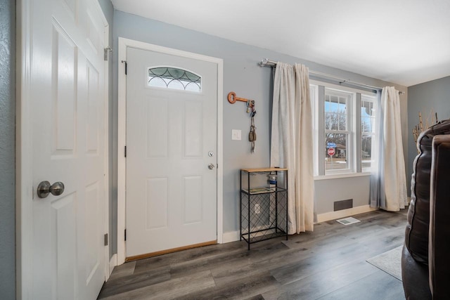 entrance foyer with baseboards and wood finished floors