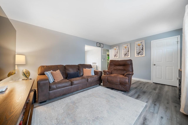 living area featuring baseboards and wood finished floors