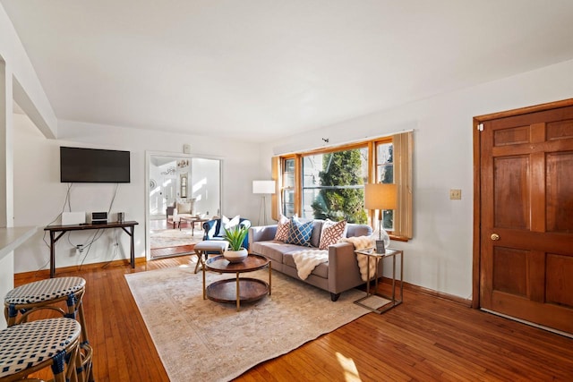 living room with hardwood / wood-style flooring and baseboards