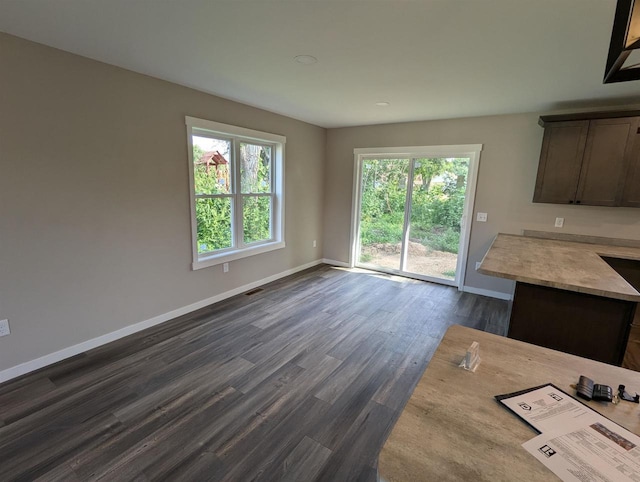 E11617 Pen-Marc Ct, Baraboo, WI 53913 - interior space featuring a healthy amount of sunlight, baseboards, and dark wood finished floors