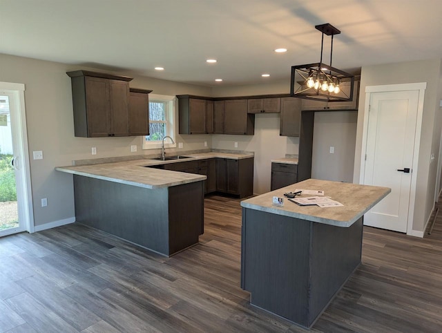 E11617 Pen-Marc Ct, Baraboo, WI 53913 - kitchen with recessed lighting, dark wood-style flooring, a sink, and a peninsula