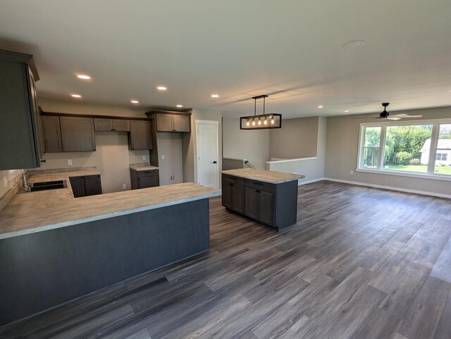 E11617 Pen-Marc Ct, Baraboo, WI 53913 - kitchen featuring dark wood-style floors, a peninsula, recessed lighting, and baseboards