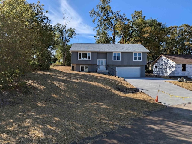 split foyer home with driveway and a garage