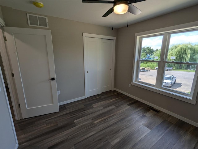 E11617 Pen-Marc Ct, Baraboo, WI 53913 - unfurnished bedroom featuring dark wood-type flooring, a closet, visible vents, and baseboards