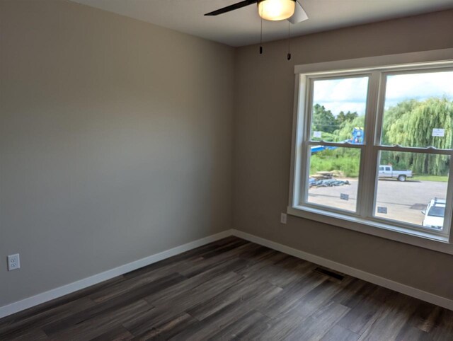 E11617 Pen-Marc Ct, Baraboo, WI 53913 - empty room with dark wood-type flooring, visible vents, baseboards, and a ceiling fan