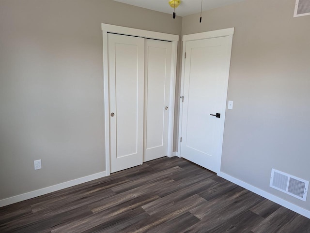 E11617 Pen-Marc Ct, Baraboo, WI 53913 - unfurnished bedroom with baseboards, visible vents, and dark wood finished floors