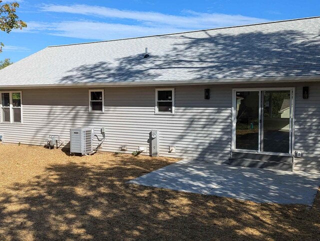 E11617 Pen-Marc Ct, Baraboo, WI 53913 - view of side of property featuring a shingled roof, a patio area, and central AC