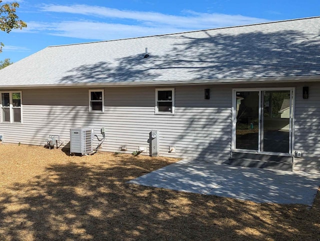 E11617 Pen-Marc Ct, Baraboo, WI 53913 - view of property exterior featuring a shingled roof, central AC, and a patio