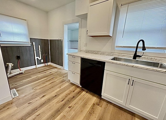 kitchen with light wood-style flooring, a sink, visible vents, white cabinetry, and dishwasher