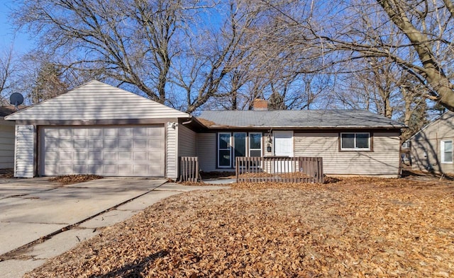 single story home featuring a garage, driveway, and a chimney