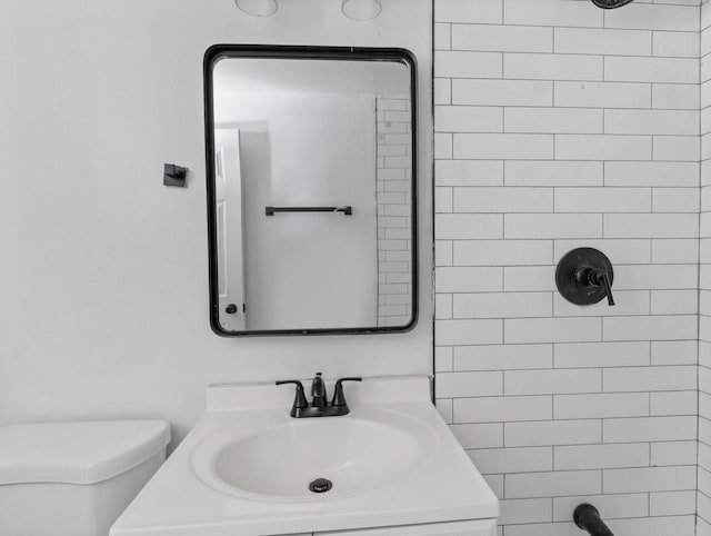 bathroom featuring toilet, walk in shower, and vanity