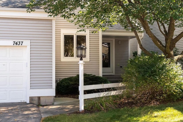 entrance to property with roof with shingles