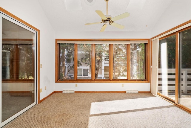 unfurnished sunroom with lofted ceiling, a healthy amount of sunlight, and visible vents