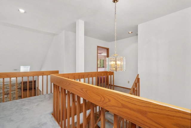 hallway with recessed lighting, a notable chandelier, carpet flooring, and an upstairs landing