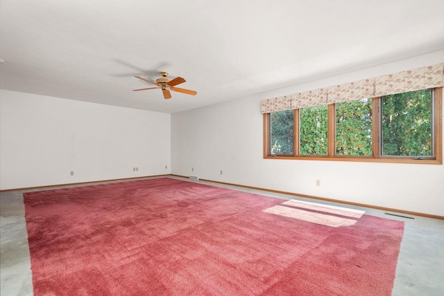 unfurnished room featuring a ceiling fan, carpet, visible vents, and baseboards