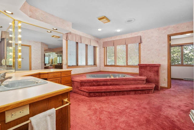 bathroom with a garden tub, a baseboard radiator, visible vents, vanity, and wallpapered walls