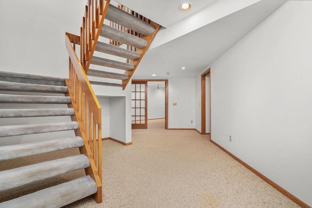 stairs with recessed lighting and baseboards