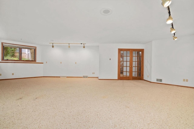 spare room with baseboards, visible vents, track lighting, and french doors