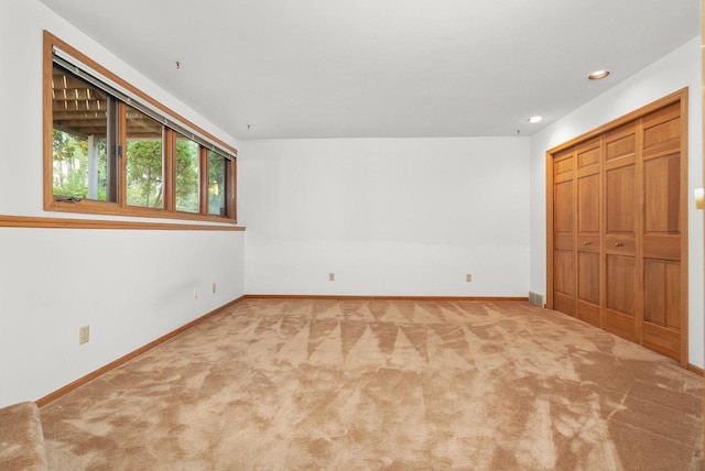 unfurnished bedroom featuring carpet floors, a closet, recessed lighting, and baseboards