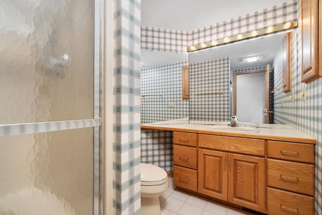 bathroom with toilet, vanity, a shower, tile patterned floors, and wallpapered walls