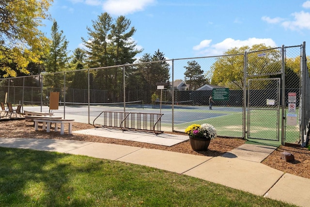 view of sport court featuring a gate and fence