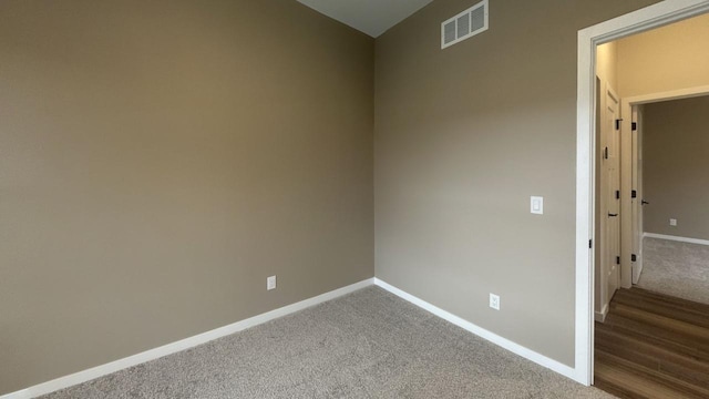 carpeted spare room with baseboards and visible vents