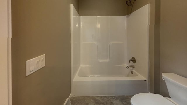 bathroom with bathing tub / shower combination and toilet