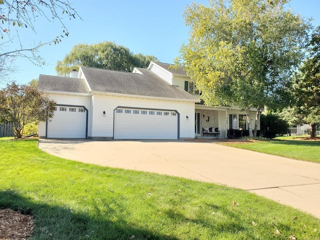 view of front of home featuring a front lawn, concrete driveway, and an attached garage