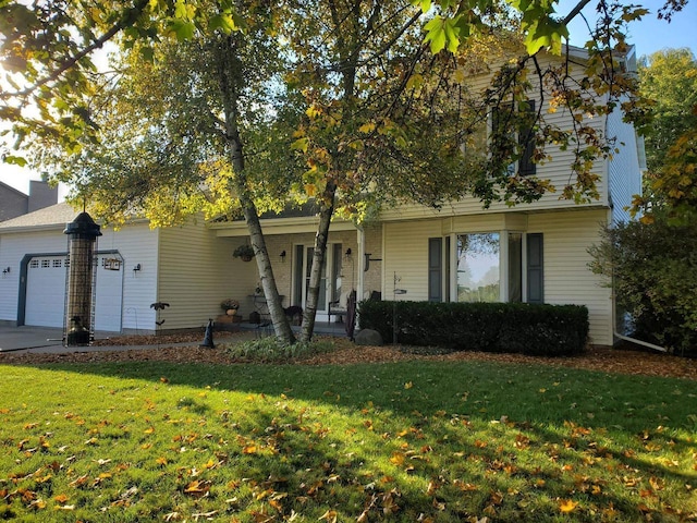 view of front of house featuring driveway, a front lawn, and an attached garage