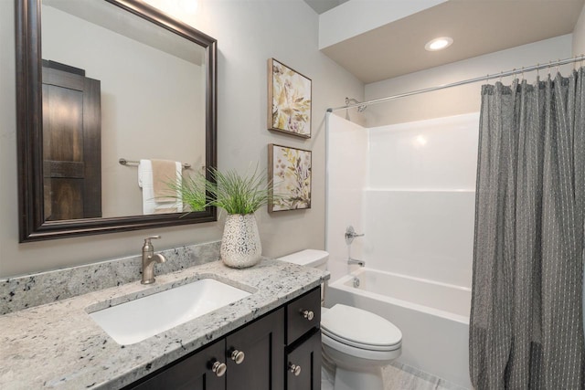 bathroom featuring shower / tub combo, vanity, and toilet