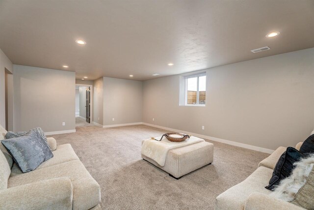 living area featuring recessed lighting, baseboards, visible vents, and light colored carpet