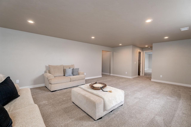 living area with visible vents, baseboards, light colored carpet, and recessed lighting