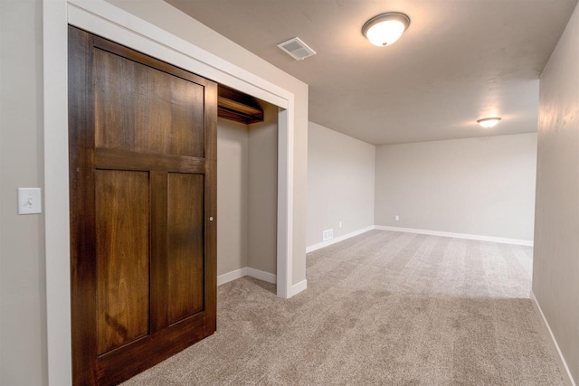 unfurnished bedroom with light colored carpet, visible vents, and baseboards