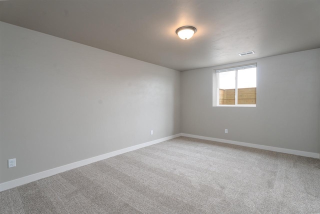 empty room with light carpet, visible vents, and baseboards